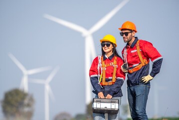 couple engineer team inspection check control wind power machine construction installation in wind energy factory. Two technician professional worker discussion for maintenance wind power turbine