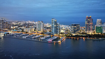 Fototapeta premium Downtown Miami marina with luxury illuminated yacht. Summer vacation. Luxury South beach marina. Luxury yacht at night. Miami south beach view. Yacht club. Marina in night Miami. Luxury yachts