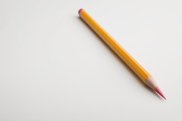 there is a pencil that is laying on a table
