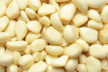 Heap of peeled garlic cloves for background. Top view