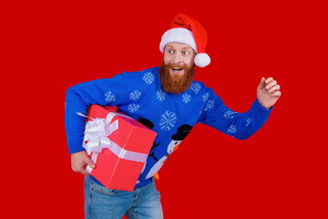Santa man hold holiday shopping gift isolated on red. Xmas present and gift. Winter shopping sale. New Year and Christmas. Xmas holiday present. Santa man hurrying for New Year sale