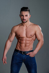 Fototapeta premium Naked strong man showing his six pack abs muscles. Topless man with muscle. Sexy male body. Handsome sexy model. Shirtless muscled male model. Man with a naked torso. Muscular perfect body.