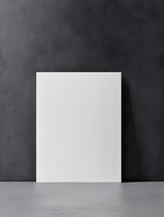 Blank white poster against a dark textured wall