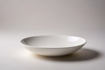 there is a white bowl sitting on a table with a white background