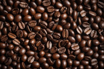 Obraz premium a close up of a pile of coffee beans with a few brown ones