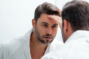 Caucasian beauty man use moisturizing face balm for healthy skin, male skincare concept. Male beauty and skin care portrait. Healthy clean face after shaving, facial treatment, skincare concept.