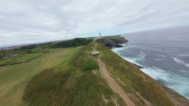 Aerial Drone Shot and orbit around the coast and lighthouse of Santander (Spain)