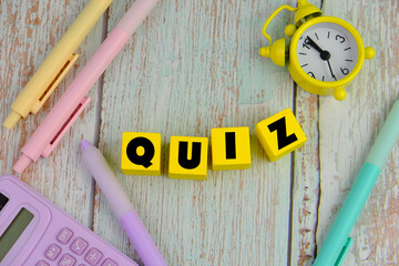 the words Its Quiz on color wooden blocks. the concept of answering quizzes or quiz games