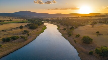 Obraz premium Serene River Landscape at Sunset with Rolling Hills and Reflections