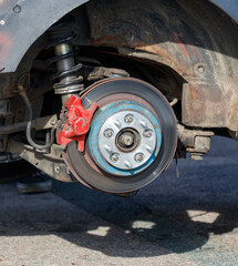 A car's brake rotors are red and blue