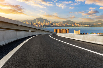 Asphalt highway road and city skyline with modern buildings scenery at sunset in Shenzhen. Outdoor city road.