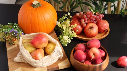  Autumn display features pumpkin, pears, pomegranates, grapes, apples with greenery, creating natural eco fruits presentation, highlighting seasonal vibe and eco-friendly harvest decor.