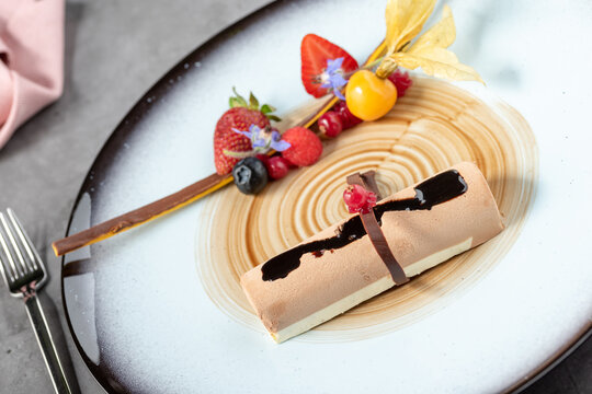 Stylish modern presentation of fruit chocolate mousse or semi-frozen parfait
