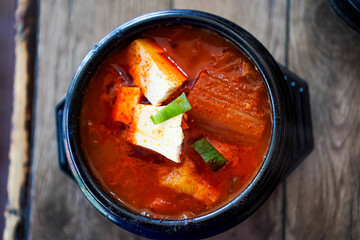 Top view photo of ready-to-eat Kimchi Soup on a dining table.
