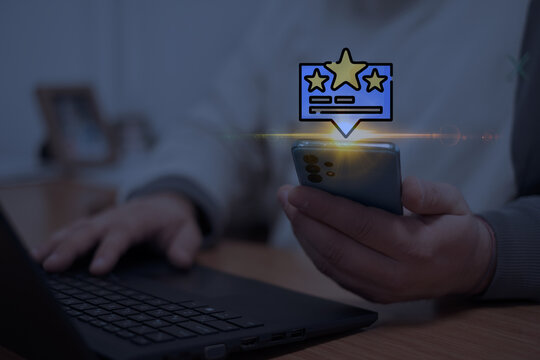 Close-up of a user holding a smartphone with a star rating and feedback icon overlay. Illustrating concepts like user reviews, online feedback systems, or customer engagement in digital media. - Powered by Adobe