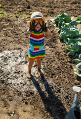 Child playing in mud. Selective focus.