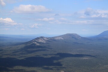 A mountain range is visible in the distance with a blue sky above