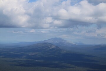 A mountain range is visible in the distance with a blue sky above