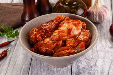 Raw marinated buffalo chicken wings