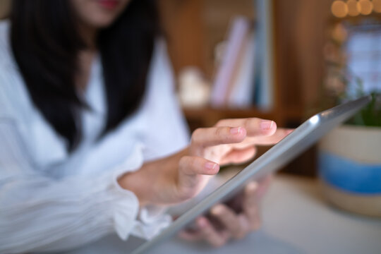 Close up business woman using tablets for creative thinking and ideas working to plan and establish relationship meetings with clients at local shops, restaurants, cafes or workplaces.