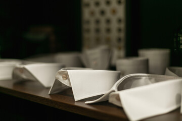 Samples of men's white shirt collars on a shelf in a tailor's shop. Close-up.