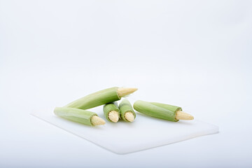 Fresh baby corn photographed on a white background