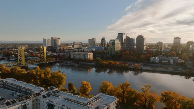 Beautiful Drone Aerial of Downtown Sacramento, CA Skyline, Tower Bridge, Sacramento River during Golden Hour, Pan Left, 4K UHD