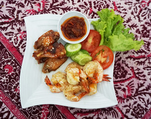 grilled chicken wings, grilled prawns, cucumber slices, tomato slices, fresh lettuce, bright colors, food presentation, culinary blogs, appetizing dishes, social media food posts, dinner plates