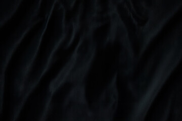 Dark black velvet fabric with soft folds and luxurious texture