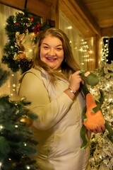 Woman Christmas Decorations Holiday Cheer - A woman smiles near Christmas decorations in her home.