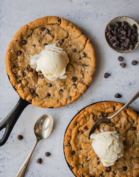 Close up of chocolate chip cookie skillets with ice cream.