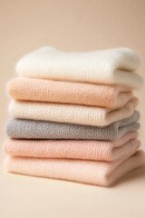 Soft folded wool sweaters in pastel colors for cozy winter fashion aesthetic