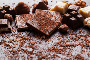 Variety of sweet homemade chocolate pralines on wooden background