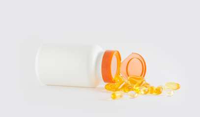 Omega-3, mockup of white vitamin supplements jar without label on a light gray background, selective focus