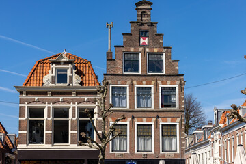 Haarlem, The Netherlands - April 19, 2023: Typical traditional Dutch old fashioned gable roof brick houses in Haarlem, Holland, The Netherlands