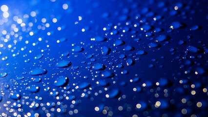 A vibrant blue background adorned with an abundance of water drops