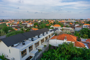 An aerial view of a village in the North Kuta district of Canggu, Bali. sunset and a gentle breeze accompany the view.