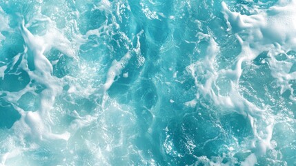 Obraz premium Aerial view of turquoise ocean water with white foamy waves.