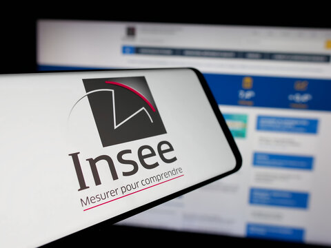 Stuttgart, Germany - 11-20-2024: Mobile phone with logo of French national statistics agency INSEE on screen in front of website. Focus on center-left of phone display.