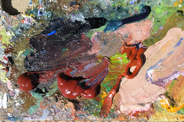 Abstract background of palette with mixed oil paints.