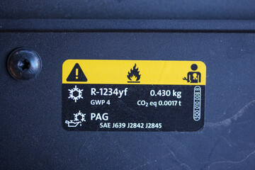 Air conditioning sticker in the engine bay of a modern vehicle