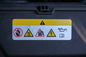Warning label in the engine bay of a new vehicle