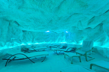 Illuminated salt cave interior with lounge chairs and therapeutic ambiance