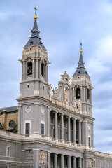 Obraz premium Facade of the Almudena Cathedral against an overcast sky, Madrid, Spain