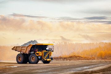 Banner open pit mine industry, big yellow mining truck for gold ore.