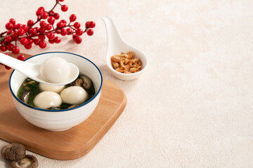 Eating big tangyuan yuanxiao with savory soup in Taiwan.