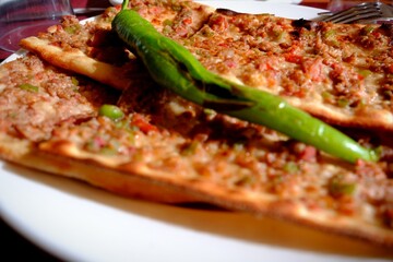 Close-up photo of Konya meat bread, a traditional taste of Turkish cuisine. Turkish food culture. Food industry, restaurant food. Types of pita bread.
