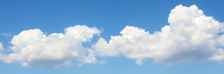 Fluffy white clouds drifting peacefully across a vibrant blue sky, natural, weather