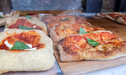 Neapolitan pizza in a restaurant display window, close up.