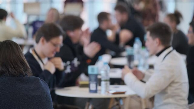 Group of professionals having discussions during a business event in a modern setting.